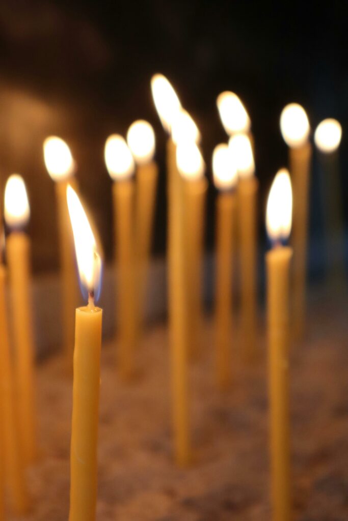 A serene arrangement of lit candles creating a warm ambiance indoors.